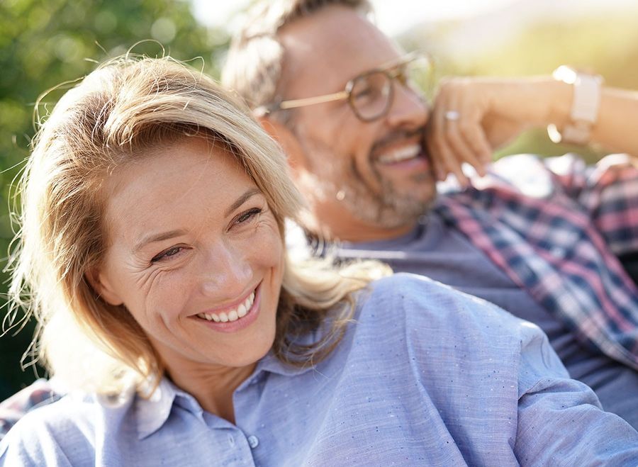 Portrait of mature couple relaxing in outdoor sofa