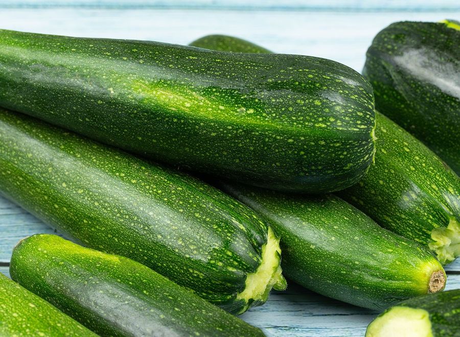 several zucchini isolated on a wooden table