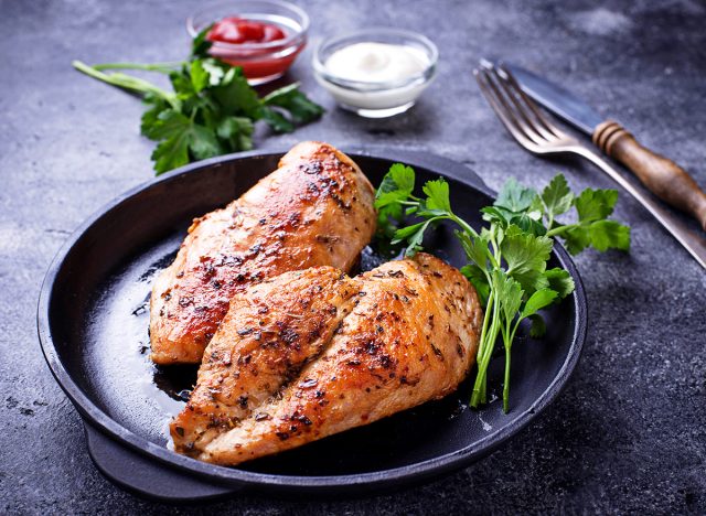 Grilled chicken breast or fillet on iron pan. Top view