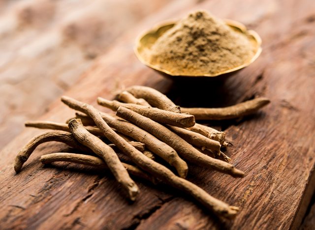 Ashwagandha / Aswaganda OR Indian Ginseng is an Ayurveda medicine in stem and powder form. Isolated on plain background. selective focus