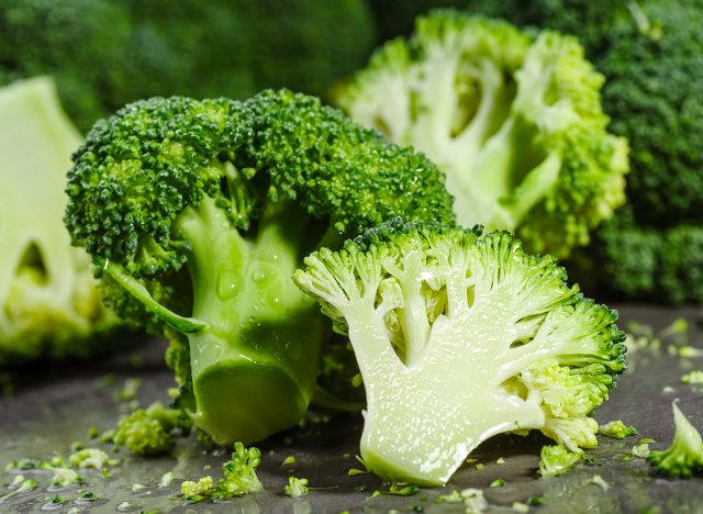 Macro photo green fresh vegetable broccoli. Fresh green broccoli on a black stone table.Broccoli vegetable is full of vitamin.Vegetables for diet and healthy eating.Organic food.