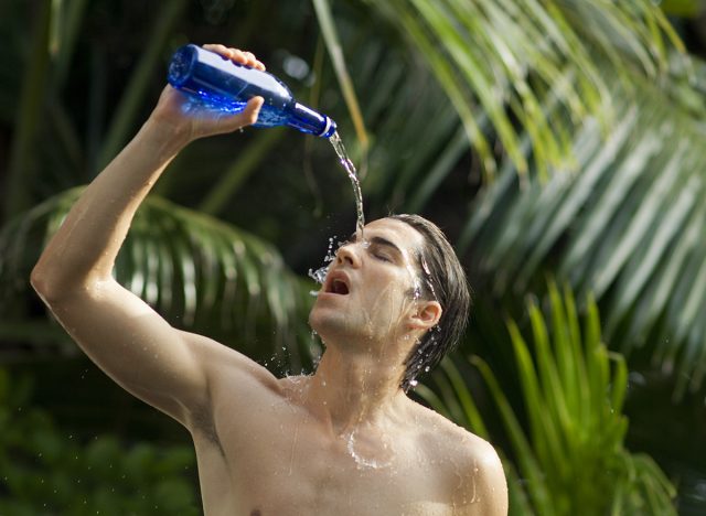 Man pouring water on face to cool off