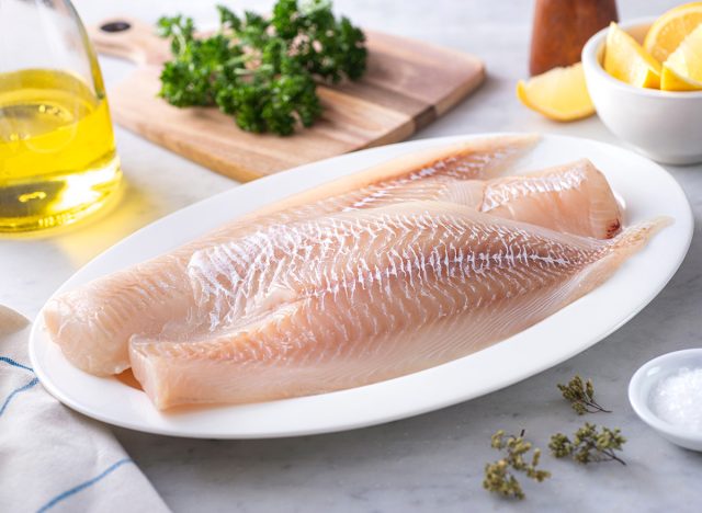 Fresh Icelandic Haddock Fillets on a plate with lemon and parsley.