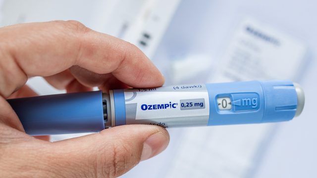 GDANSK, POLAND - MAY 2022: obese fat man preparing Semaglutide Ozempic injection control blood sugar levels