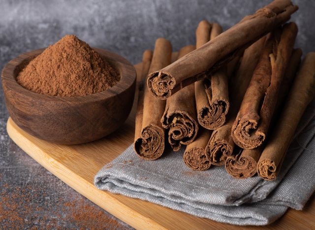 Cinnamon sticks on a wooden background. Cinnamon spice in a spoon and bowl. Ceylon cinnamon.