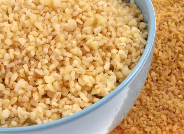 Bowl of cooked bulgur and raw bulgur close-up