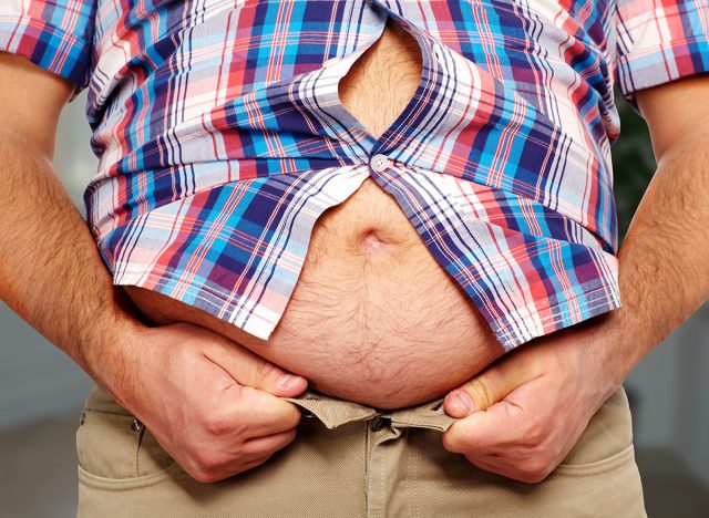 Fat belly. Man with overweight abdomen. Weight loss concept.