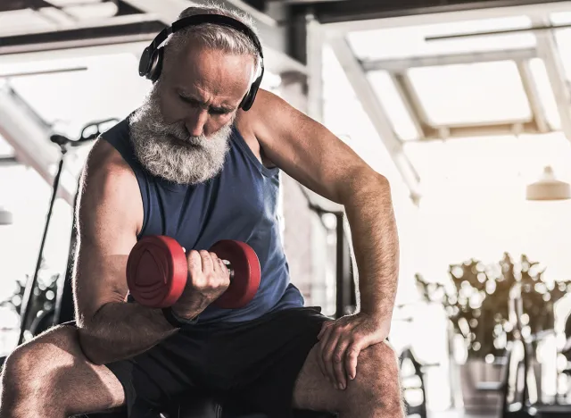 Confident old pensioner is spending time in gym