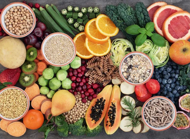Vegan health food concept for high fibre diet with fruit, vegetables, cereals, whole wheat pasta, grains, legumes, herbs. Foods high in antioxidants and vitamins. Immune system boosting. Flat lay.