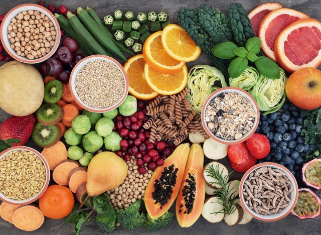 Vegan health food concept for high fibre diet with fruit, vegetables, cereals, whole wheat pasta, grains, legumes, herbs. Foods high in antioxidants and vitamins. Immune system boosting. Flat lay.