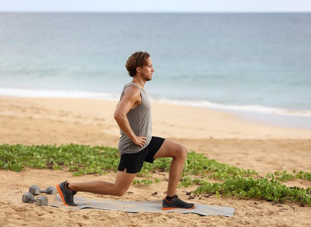 Fitness man doing lunges leg exercise lunge exercising legs. Male fitness model doing alternating bodyweight Lunge workout training glutes, hamstrings and quadriceps.