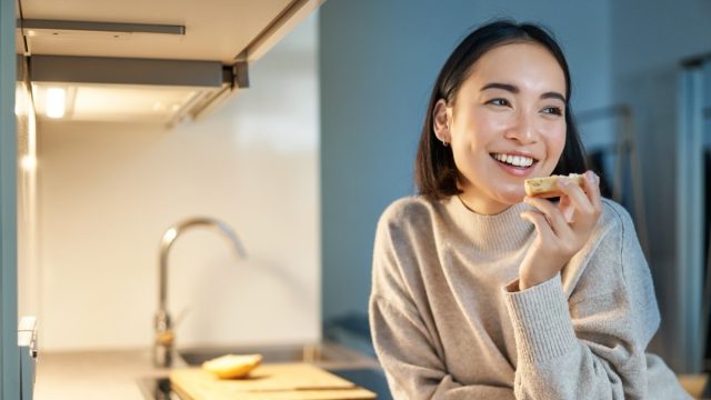 Portrait,Of,Smiling,Young,Happy,Woman,Staying,At,Home,,Standing
