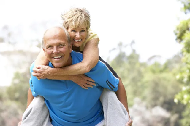 Senior Couple Exercising In Park