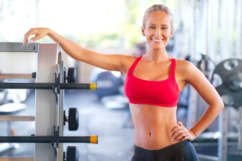 Woman, gym and workout for training, wellness and cardio health for weight exercise