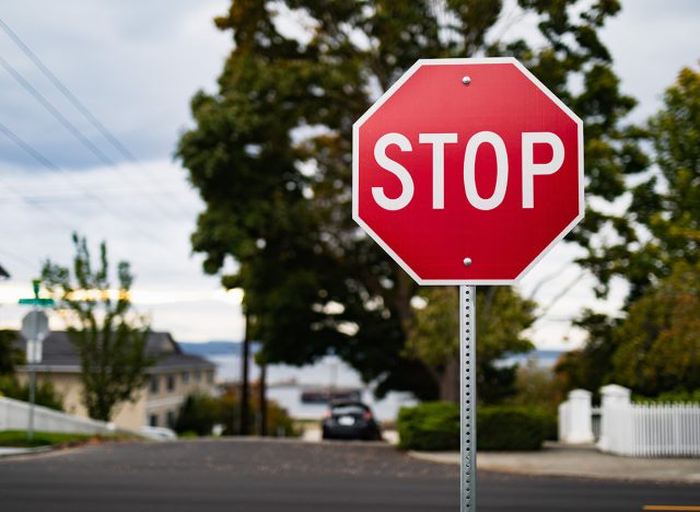 A close up photo of a red stop sign in a residential neighborhood.