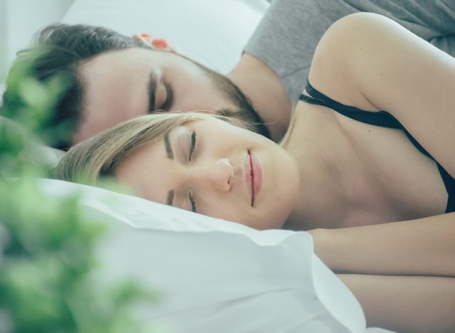 loving couple sleeping in bed.happy couple lying together in bed.women with husband sleeping in bedroom