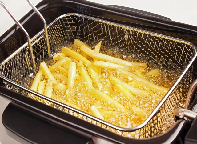 French fries in hot fat in a deep fryer