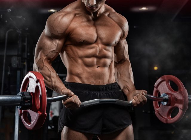 bald brutal sexy strong bodybuilder athletic fitness man pumping up abs muscles workout bodybuilding concept background