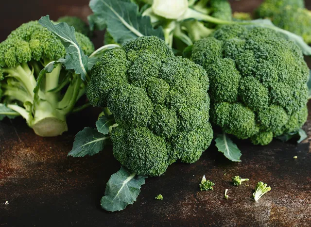 Fresh green broccoli on a dark brown background. Macro photo green fresh vegetable broccoli. Green Vegetables for diet and healthy eating. Organic food.