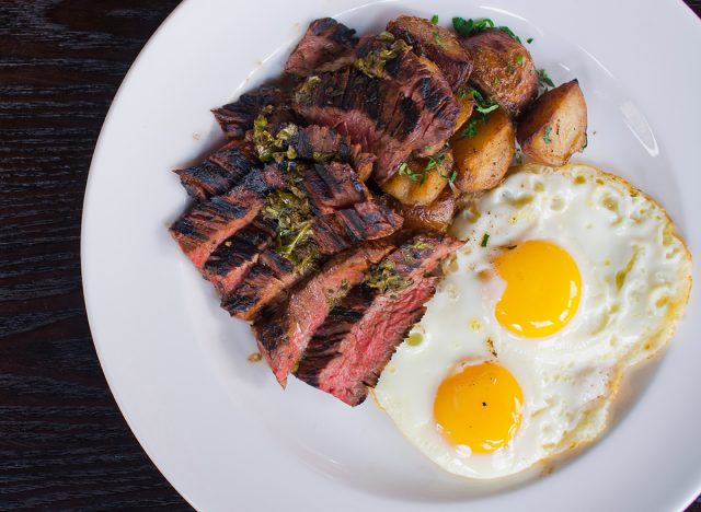 Steak and Eggs. Steak, served medium rare with eggs scrambled or sunny side up, toast and potato hash. Traditionally classical American or French Bistro breakfast or brunch favorite: steak and eggs.