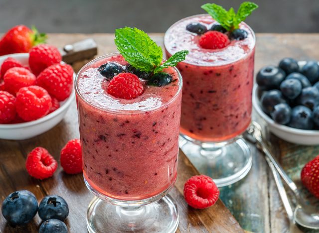 Mixed berry smoothie garnished with fresh fruit and mint