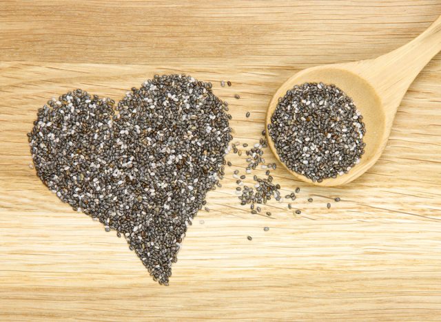 wooden spoon filled with black chia seeds and heart symbol