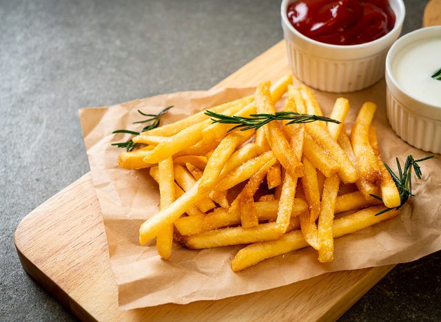 French fries or potato chips with sour cream and ketchup