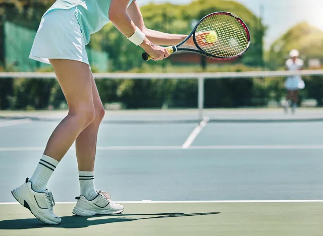 Tennis serve, sports and woman with legs on outdoor court, fitness motivation and competition with athlete training. Workout, healthy and player on turf, active with sport and exercise with action