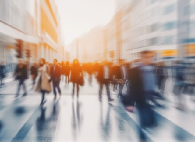 Pedestrian blur, crowd of people walking in London city, panoramic view of people crossing the street