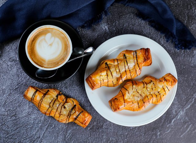 Apple Danish served plate with cup of coffee late art top view of french breakfast baked food item