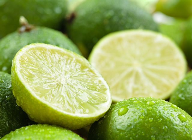 Backgrounds. Close up shot of wet limes. Focus on the central part of sliced lime.