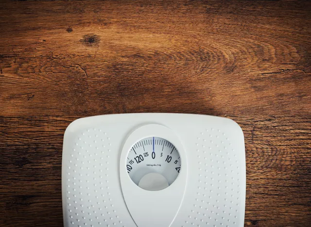 White scale on a wooden table top view, fitness and weight loss concept