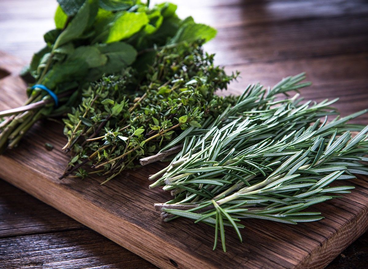 bunch of garden fresh herbs on wooden board from above