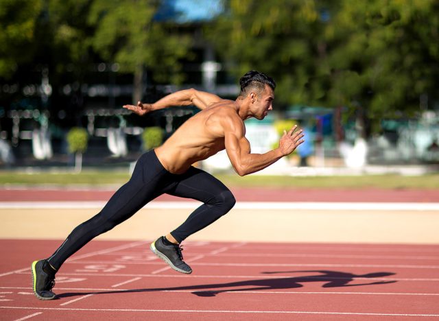 Young muscular man in gym doing exercise. Showing his muscles.