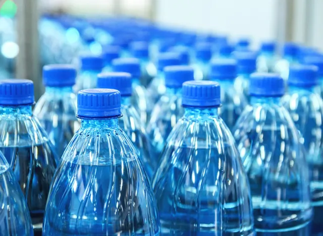 Closeup on mineral water bottles in raw and lines