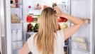 Rear View Of Young Woman Looking In Fridge At Kitchen