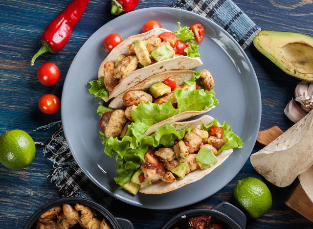 Authentic mexican tacos with chicken and salsa with avocado, tomatoes and chillies. Mexican cuisine. Top view