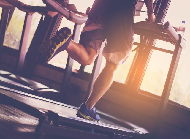 People running in machine treadmill at fitness gym