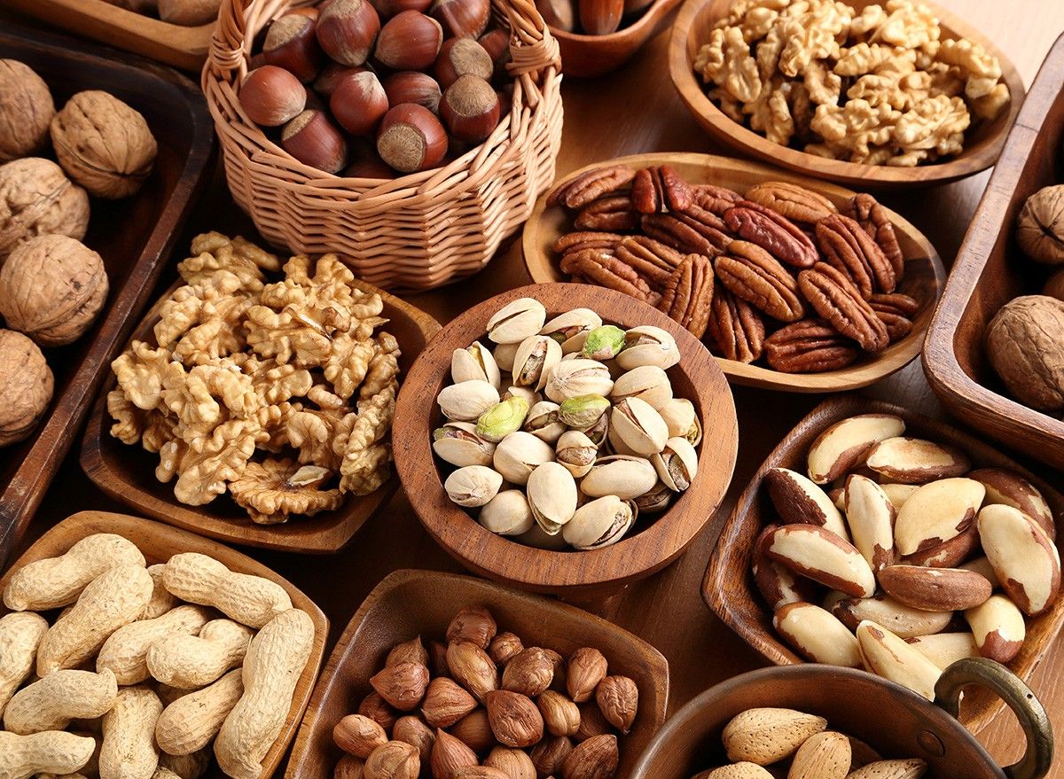 A variety of nuts in wooden bowls.