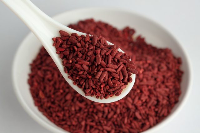 Dried red yeast rice on bowl and spoon
