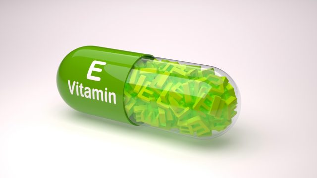 Orange pill or capsule filled with vitamin E.3D Rendering.