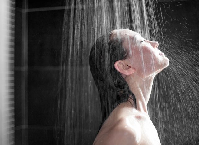 Attractive Mixed Asian Female side view enjoying shower