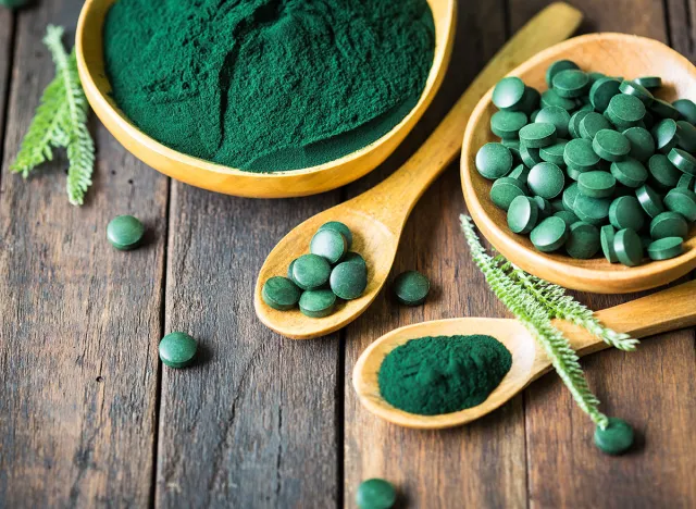 Spirulina powder and tablets in the bowl