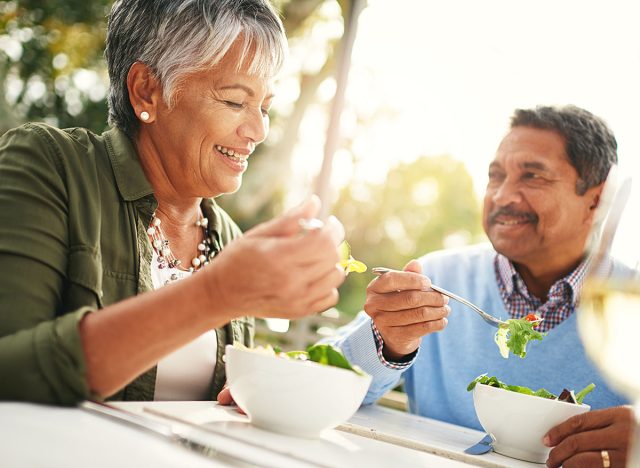 Healthiness and happiness go hand in hand. Shot of a happy older couple enjoying a healthy lunch together outdoors.