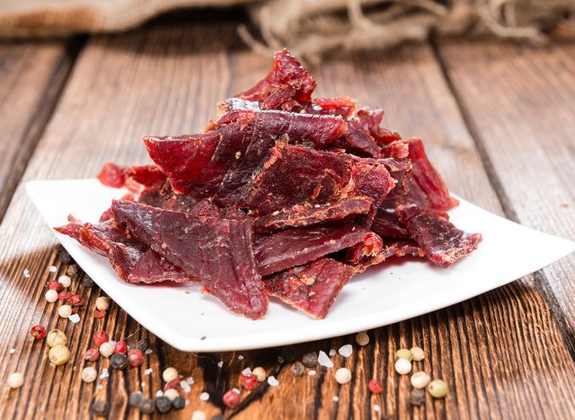 Portion of Beef Jerky on vintage wooden background