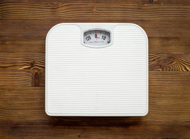 Check your body shape with white weight scales, top view.