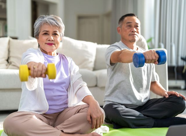 Portrait of sport senior asian couple training and sitting relax practicing yoga, elderly health, fitness, exercise, wellness, workout, sport at home.retirement concept.Fitness and senior healthy