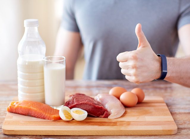 sport, fitness, healthy lifestyle, diet and people concept - close up of man with food rich in protein showing thumbs up