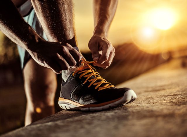 Man tying jogging shoes