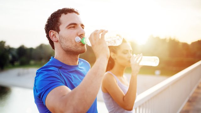 Couple staying hydrated after workout